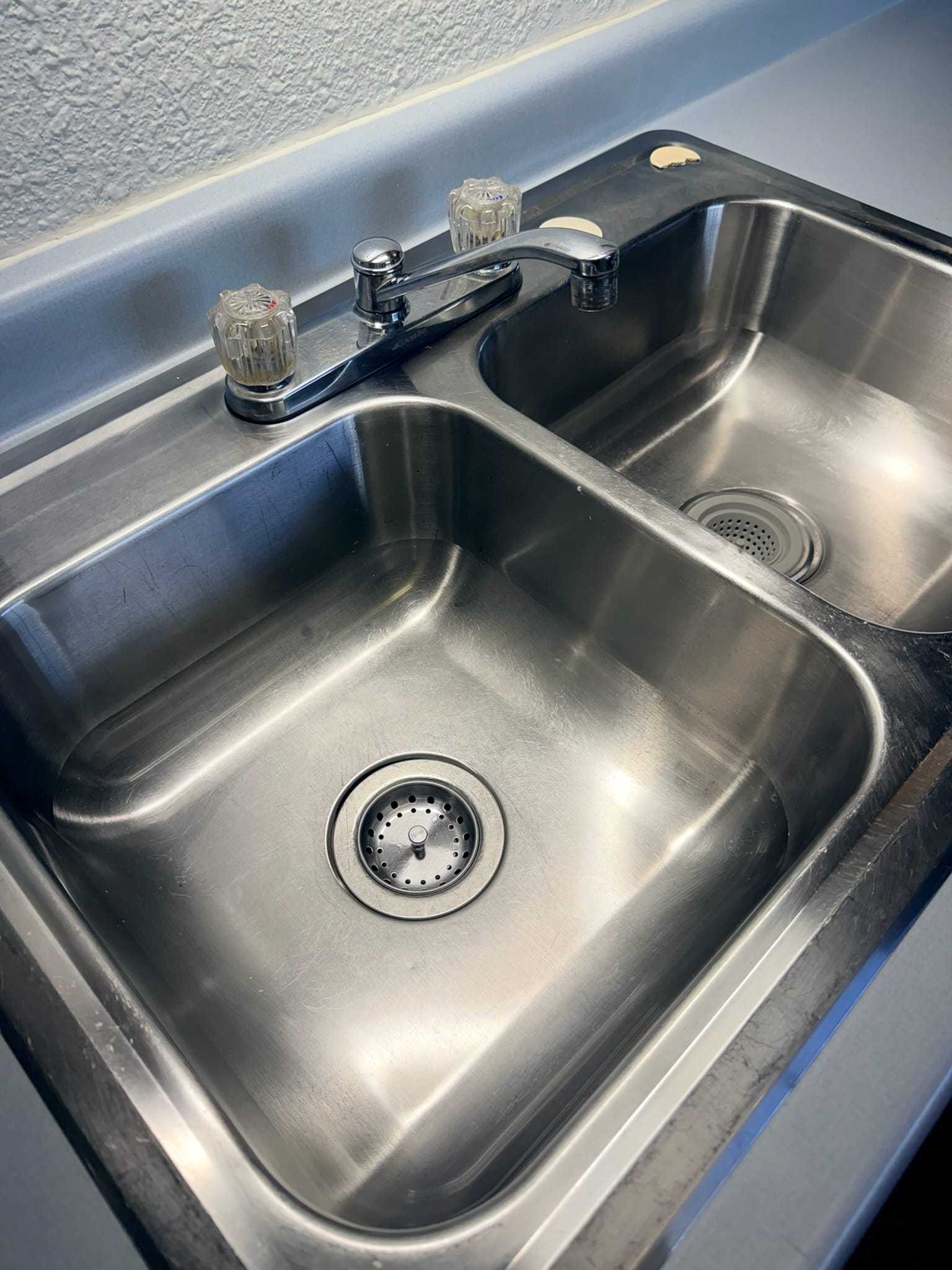 Clean kitchen sink maintained with recurring housekeeping by Alston Cleaning
