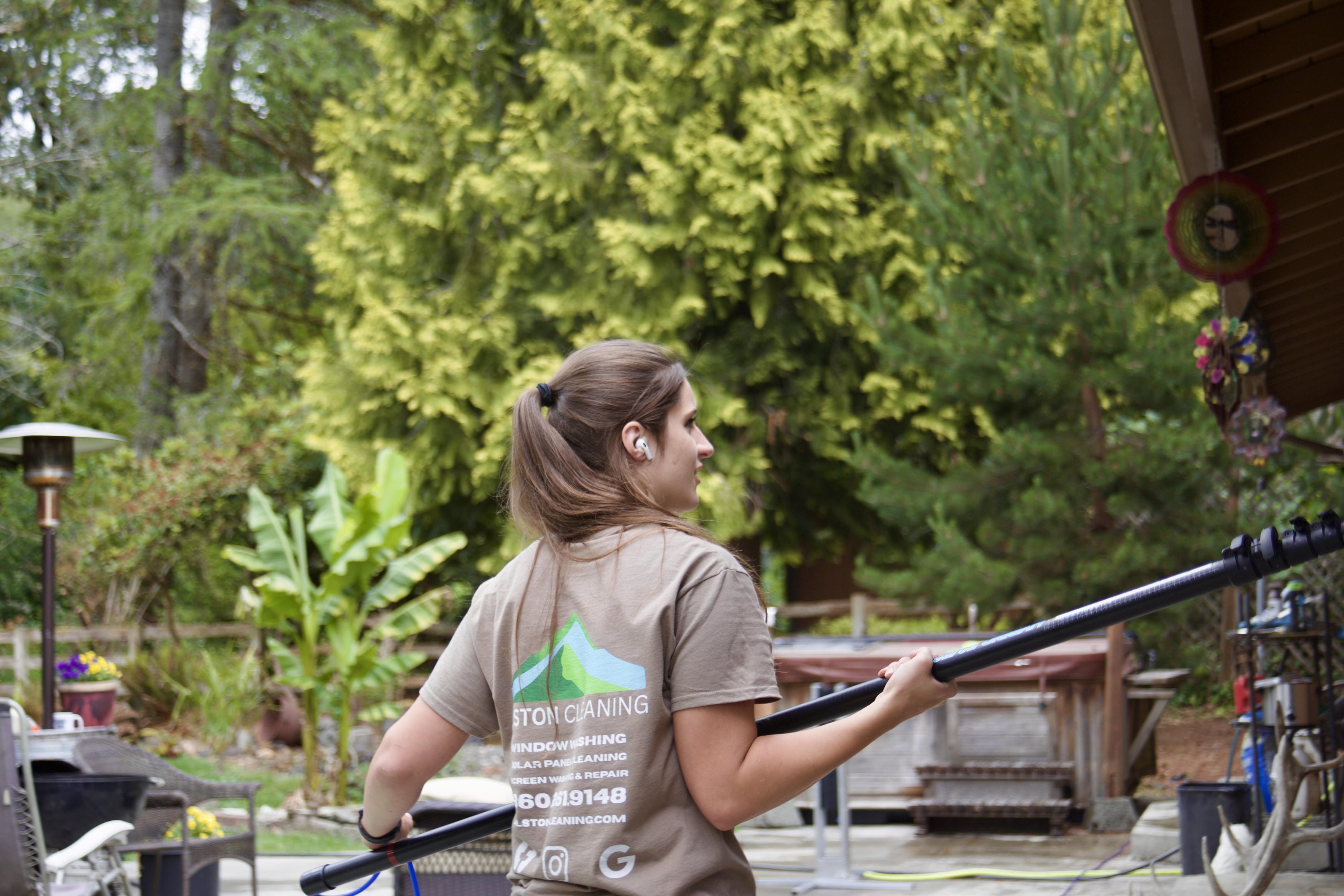 Alston Cleaning technician with professional outdoor cleaning equipment in Longview