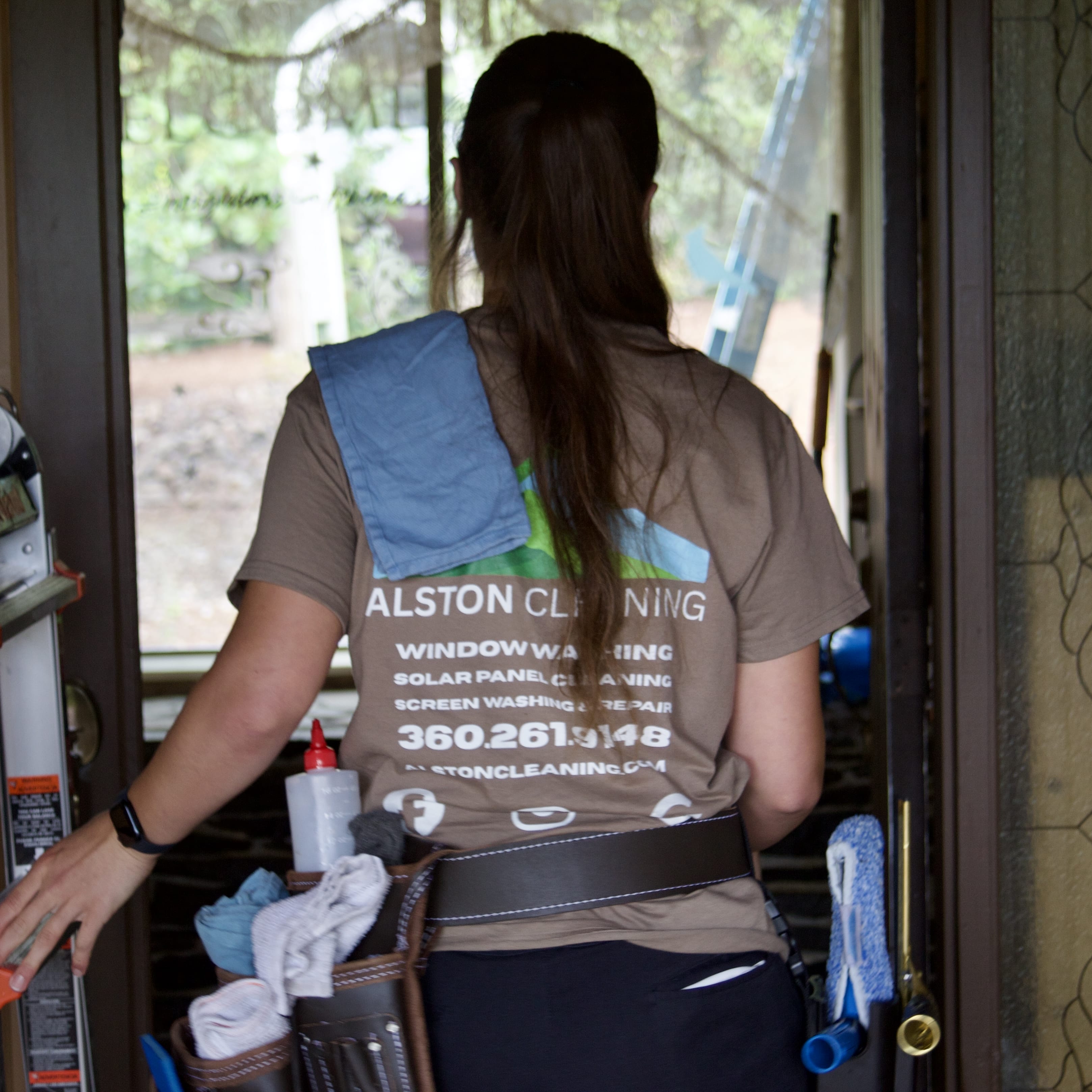 Window washing technician ready with tool belt and supplies