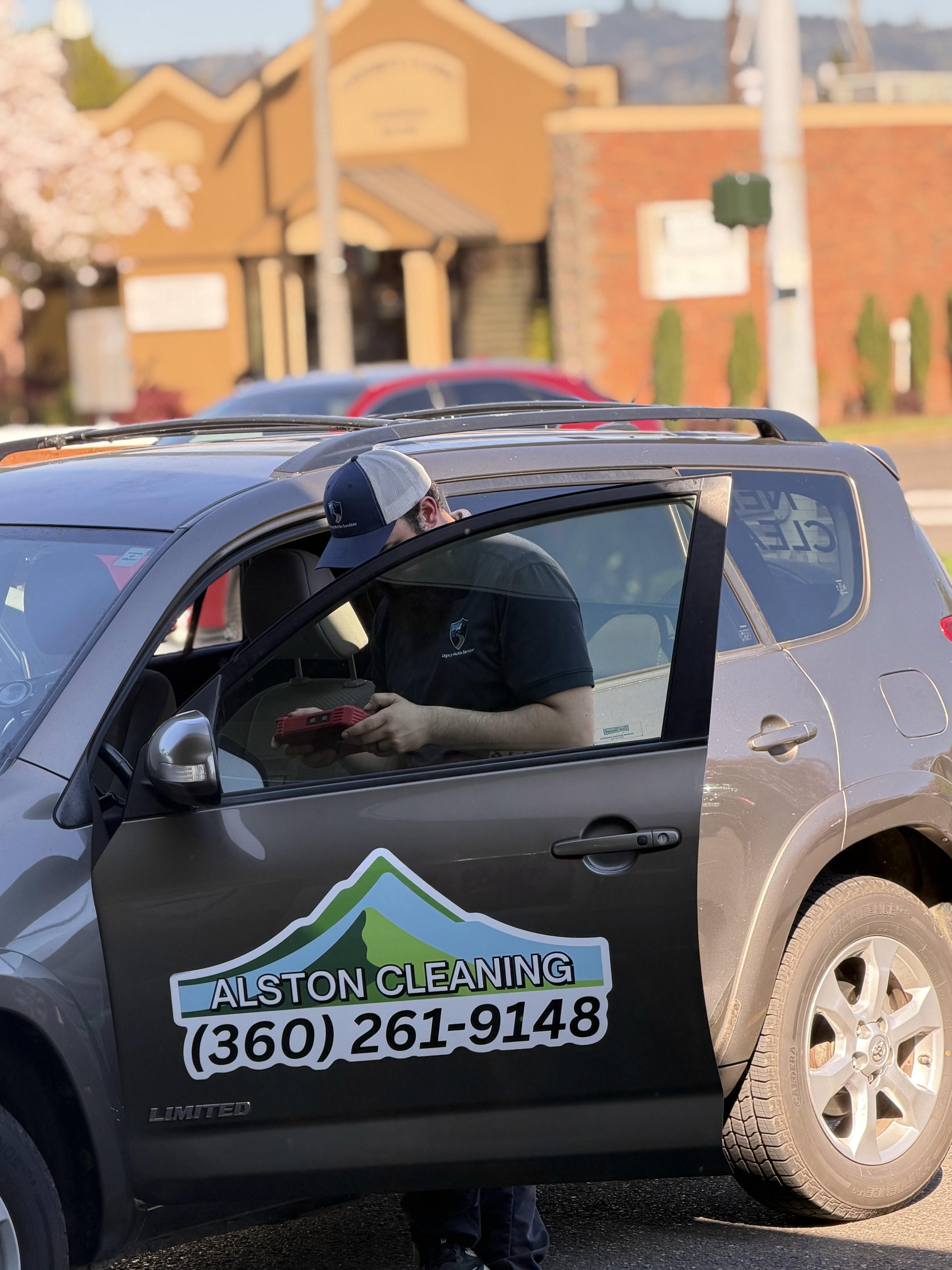 Alston Cleaning technician with branded service vehicle in Longview, Cowlitz County